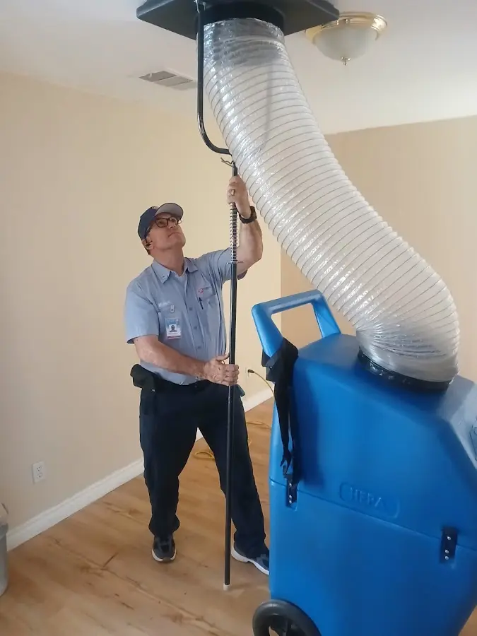 Furnace Tune-Up technician using HEPA equipment in Lake San Marcos